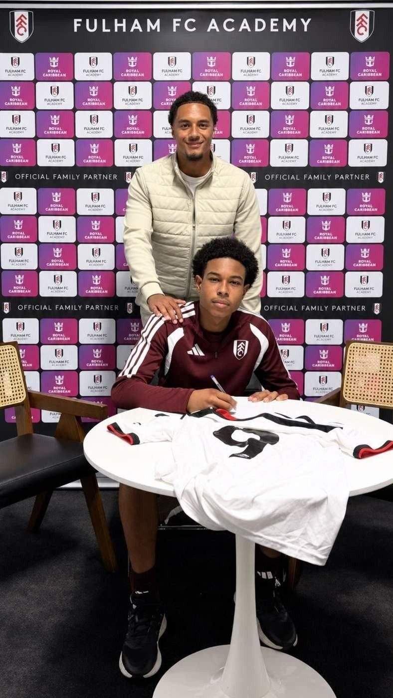 Player signing at a Fulham FC Academy partner backdrop