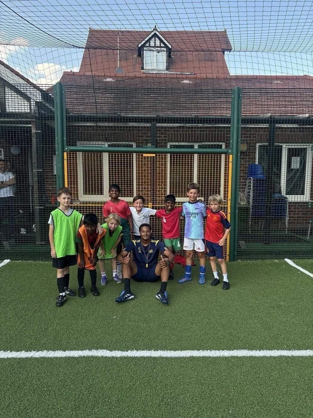 WorkRate Coaching group of young players with their coach after a football session at Mora
