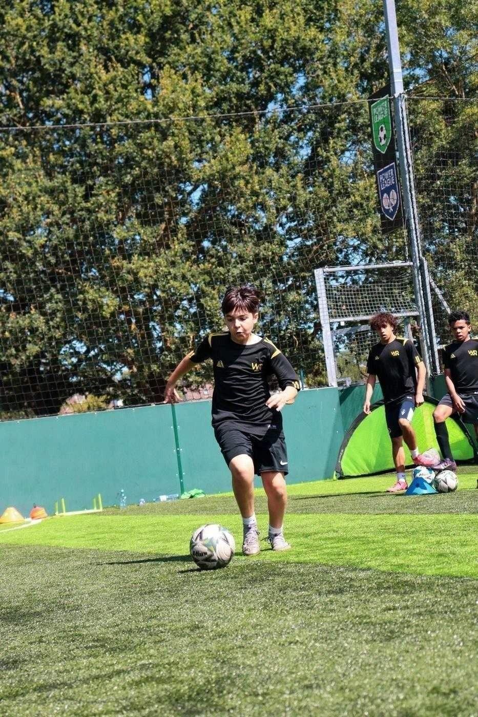 Young player developing ball control on the pitch
