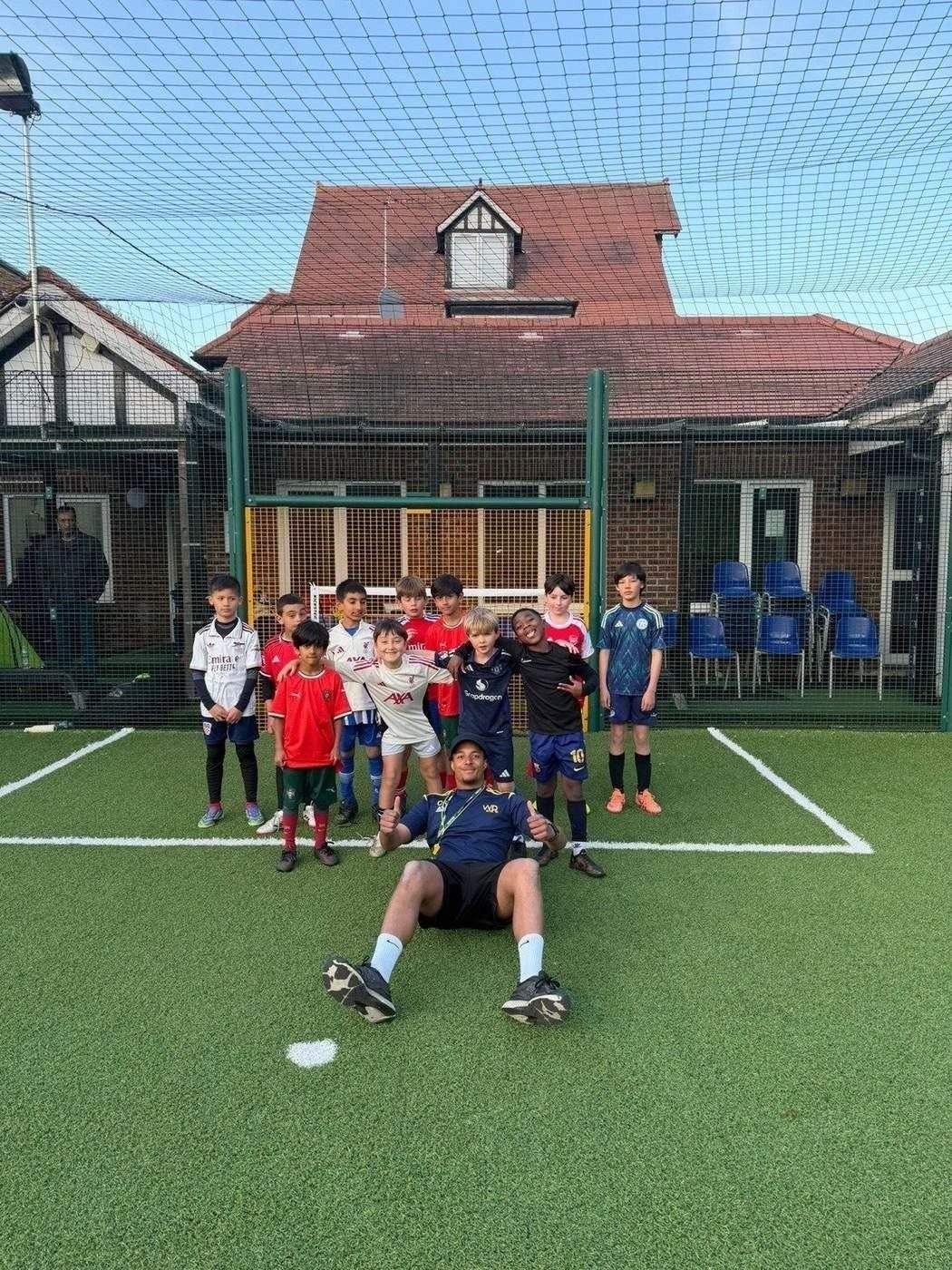 Youth players with their coach at the training venue